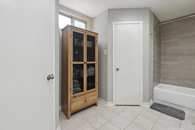 6927 Country Rose, San Antonio, TX 78240 - bathroom with tile patterned flooring,  shower combination, baseboards, and a textured ceiling