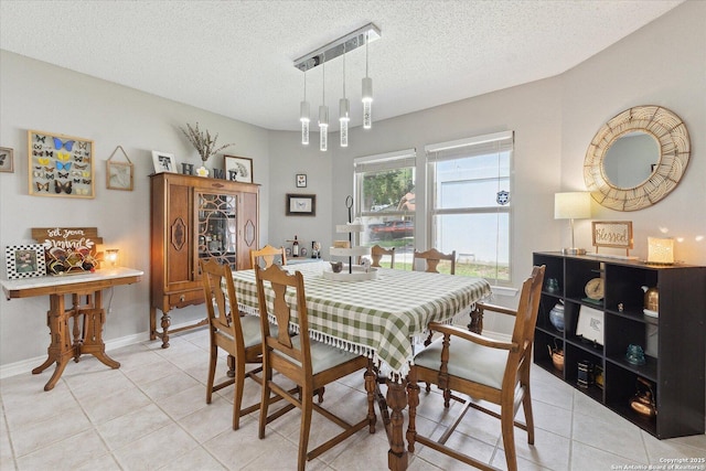 6927 Country Rose, San Antonio, TX 78240 - dining space featuring baseboards, a textured ceiling, and light tile patterned floors