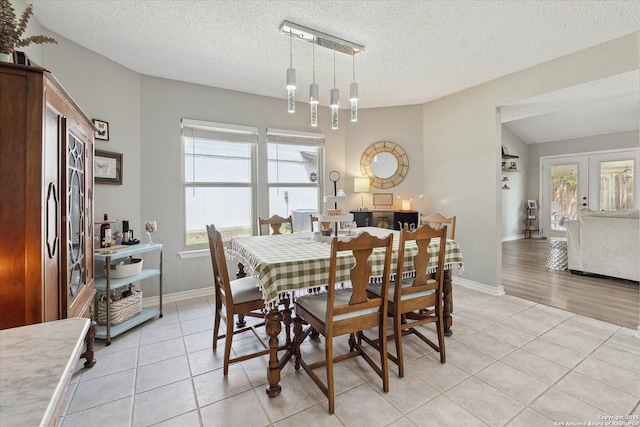 6927 Country Rose, San Antonio, TX 78240 - dining room with light tile patterned floors, baseboards, plenty of natural light, and a textured ceiling