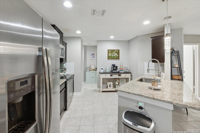 6927 Country Rose, San Antonio, TX 78240 - kitchen with appliances with stainless steel finishes, a sink, recessed lighting, light tile patterned floors, and visible vents