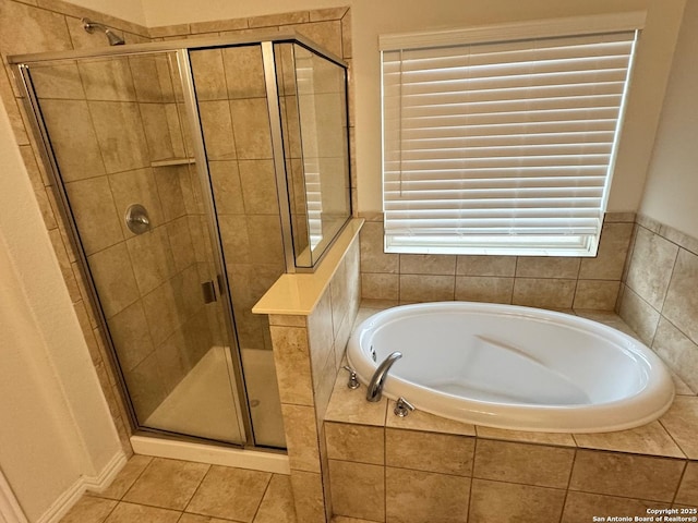 bathroom featuring a bath, a stall shower, and tile patterned floors
