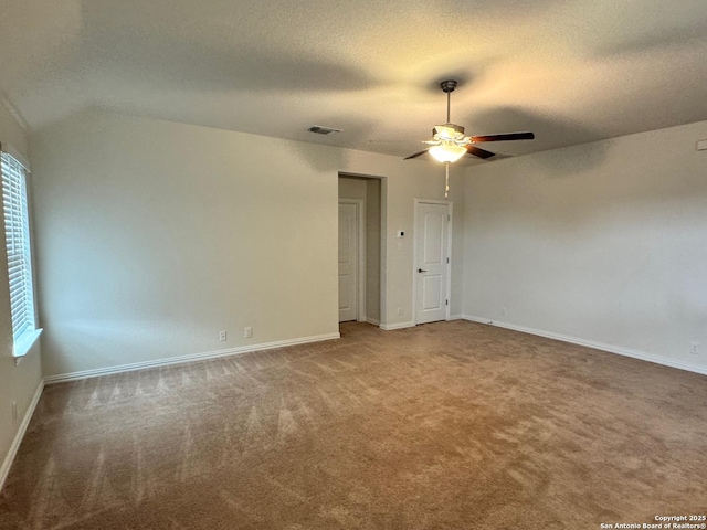 unfurnished room with visible vents, carpet flooring, baseboards, a textured ceiling, and a ceiling fan