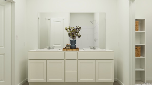 5219 Whirling Pl, San Antonio, TX 78253 - bathroom with a sink, baseboards, and double vanity