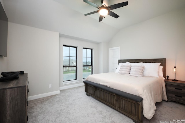 bedroom with baseboards, light colored carpet, ceiling fan, and vaulted ceiling