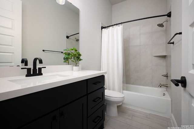 bathroom with toilet, shower / bath combo with shower curtain, wood finished floors, and vanity