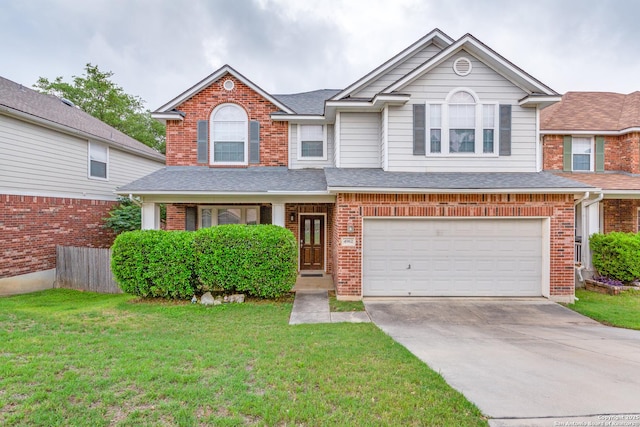 traditional home featuring roof with shingles, a front lawn, brick siding, a garage, and driveway