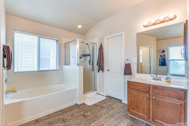 full bathroom with a garden tub, vaulted ceiling, a shower stall, wood finished floors, and vanity