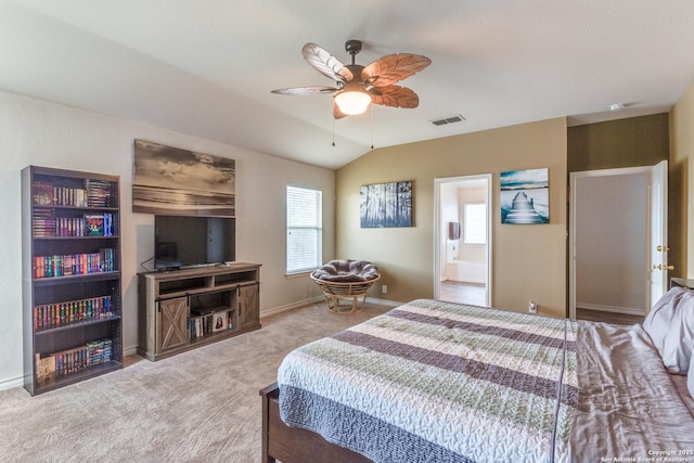 bedroom featuring visible vents, baseboards, lofted ceiling, carpet, and ensuite bath