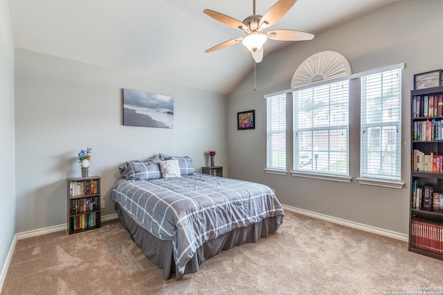 carpeted bedroom with baseboards, ceiling fan, and vaulted ceiling