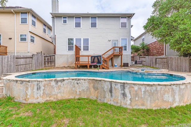 view of swimming pool with a fenced backyard, a fenced in pool, an in ground hot tub, and a wooden deck