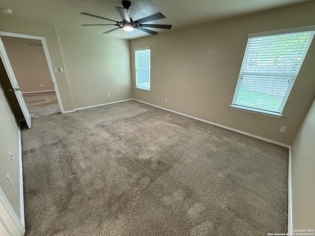 unfurnished bedroom with baseboards, a ceiling fan, and carpet