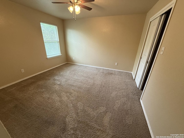 interior space with baseboards and ceiling fan