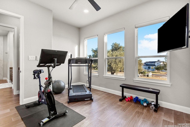 exercise room featuring baseboards, ceiling fan, recessed lighting, and wood finished floors