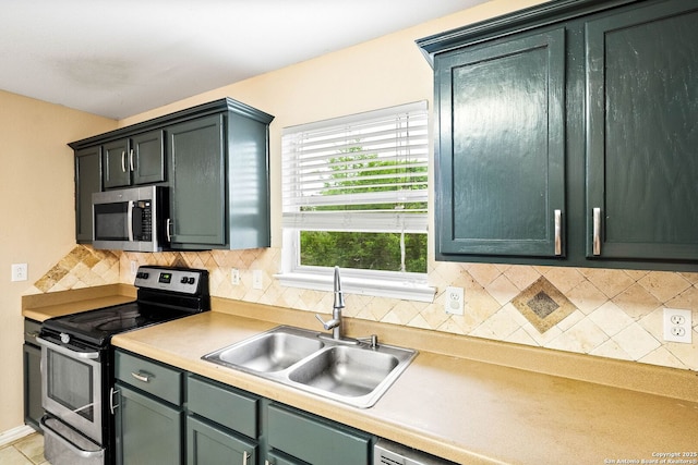 kitchen with light countertops, a sink, backsplash, and stainless steel appliances