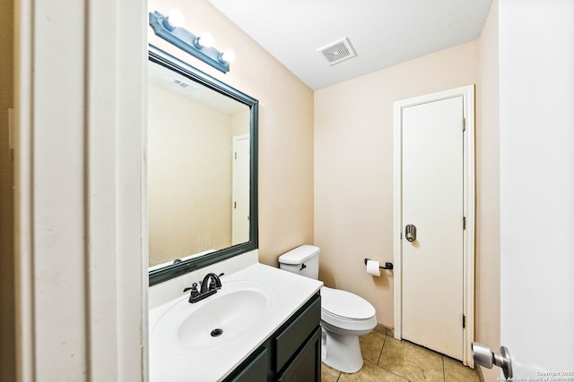 bathroom with tile patterned floors, vanity, toilet, and visible vents