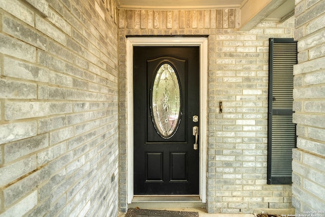 property entrance with brick siding