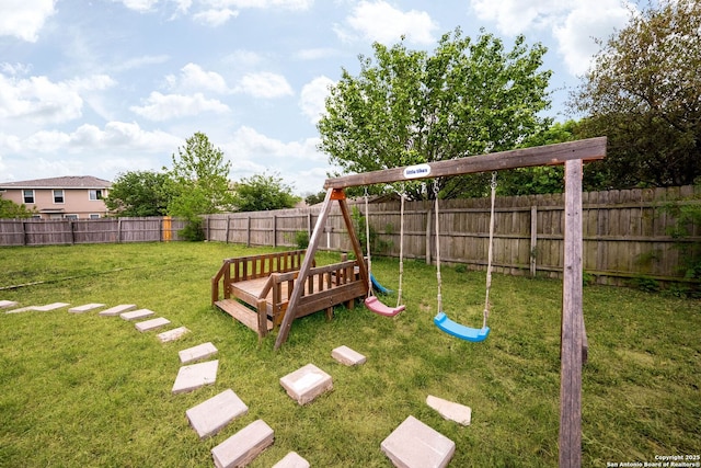 view of yard featuring a playground and a fenced backyard