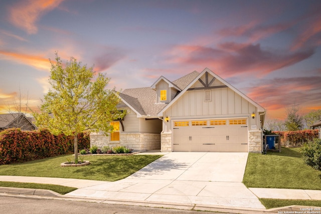 craftsman inspired home with an attached garage, stone siding, board and batten siding, concrete driveway, and a yard
