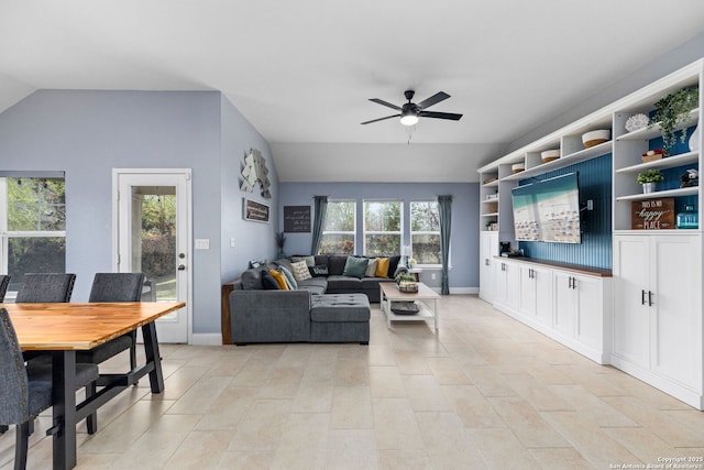 living room featuring light tile patterned flooring, ceiling fan, and vaulted ceiling