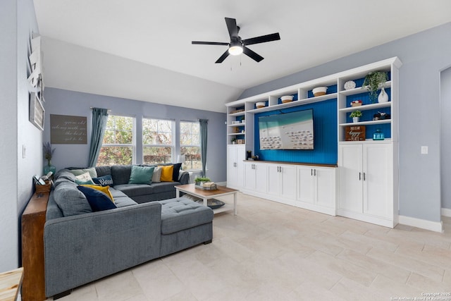 living area with a ceiling fan and lofted ceiling
