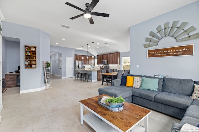 living area featuring a ceiling fan, visible vents, arched walkways, light tile patterned floors, and recessed lighting
