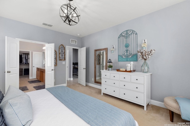 bedroom featuring visible vents, connected bathroom, baseboards, and light carpet