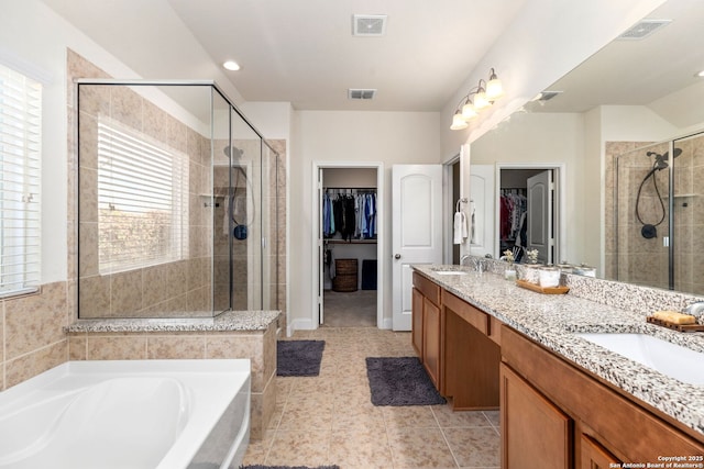 full bathroom featuring visible vents, a sink, and a stall shower