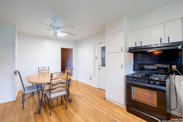 239 Sharon Dr, San Antonio, TX 78216 - kitchen featuring a ceiling fan, black gas range oven, light wood-style floors, under cabinet range hood, and white cabinetry