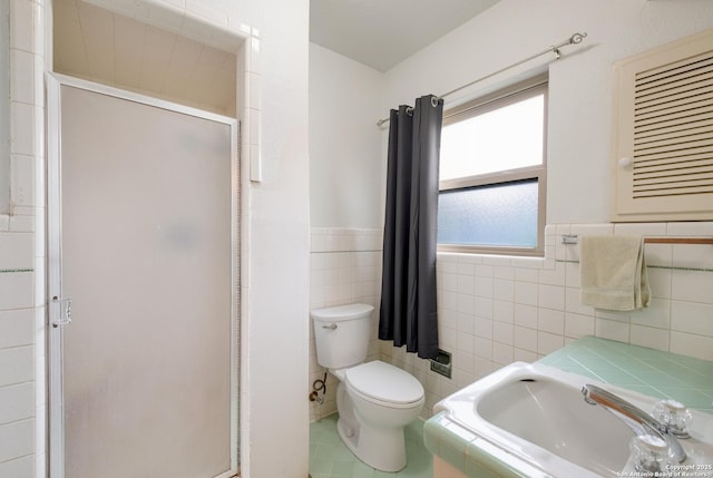 239 Sharon Dr, San Antonio, TX 78216 - full bathroom featuring tile walls, a stall shower, a sink, a wainscoted wall, and toilet