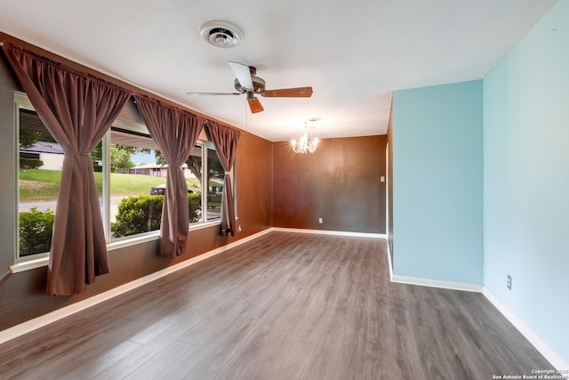 239 Sharon Dr, San Antonio, TX 78216 - spare room featuring baseboards, ceiling fan with notable chandelier, wood finished floors, and visible vents