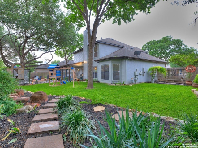 view of yard with a playground and a fenced backyard