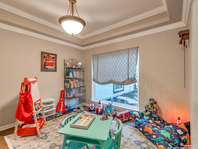 playroom featuring baseboards, ornamental molding, and wood finished floors