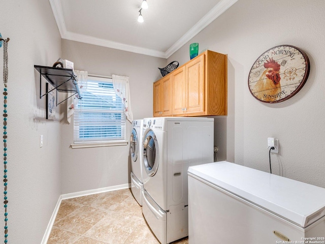 clothes washing area with crown molding, separate washer and dryer, baseboards, and cabinet space