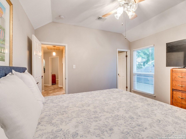 bedroom featuring visible vents, attic access, ceiling fan, and vaulted ceiling