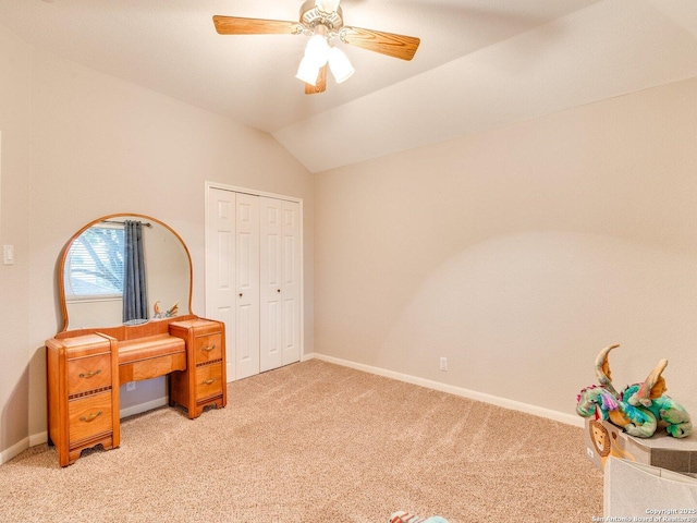 unfurnished bedroom featuring baseboards, light carpet, ceiling fan, and lofted ceiling