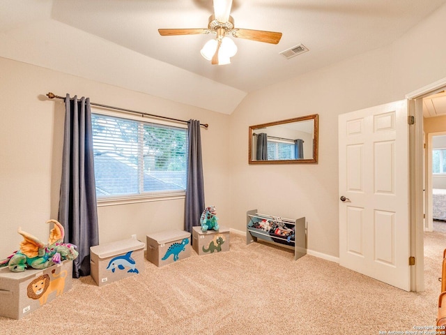 playroom with visible vents, a ceiling fan, attic access, carpet flooring, and vaulted ceiling