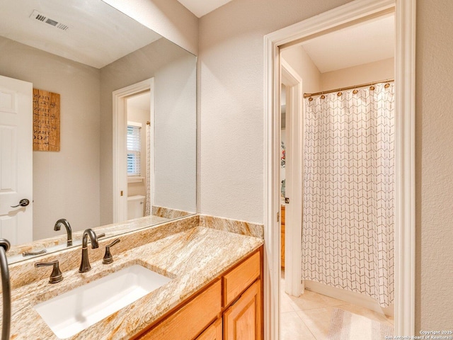 full bath with visible vents, curtained shower, tile patterned flooring, and vanity