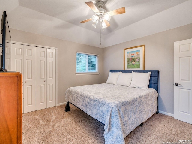 carpeted bedroom featuring baseboards, ceiling fan, and a closet