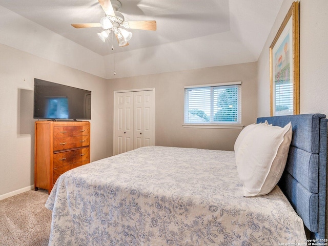 bedroom with ceiling fan, light colored carpet, baseboards, lofted ceiling, and a closet