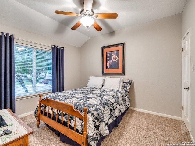 bedroom featuring baseboards, a ceiling fan, vaulted ceiling, and light colored carpet
