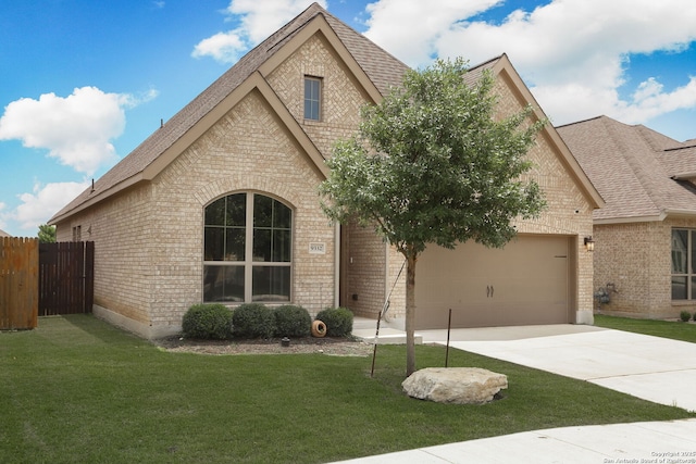 9332 Aggie Run, San Antonio, TX 78254 - view of front of home with a shingled roof, an attached garage, driveway, and brick siding