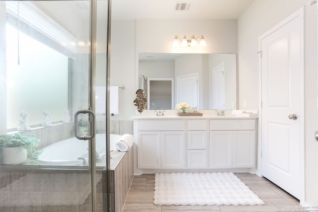 9332 Aggie Run, San Antonio, TX 78254 - bathroom with visible vents, a sink, a bath, and double vanity