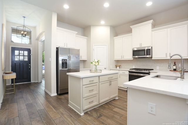 9332 Aggie Run, San Antonio, TX 78254 - kitchen with appliances with stainless steel finishes, a center island, a sink, recessed lighting, and white cabinetry
