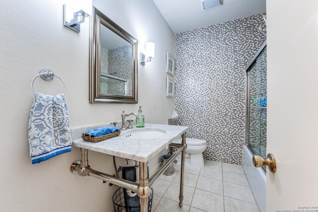7731 Broadway Unit I-42, San Antonio, TX 78209 - full bathroom featuring visible vents, a sink, tile patterned floors, combined bath / shower with glass door, and toilet