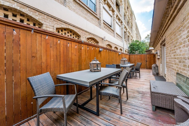7731 Broadway Unit I-42, San Antonio, TX 78209 - wooden terrace with fence and outdoor dining area