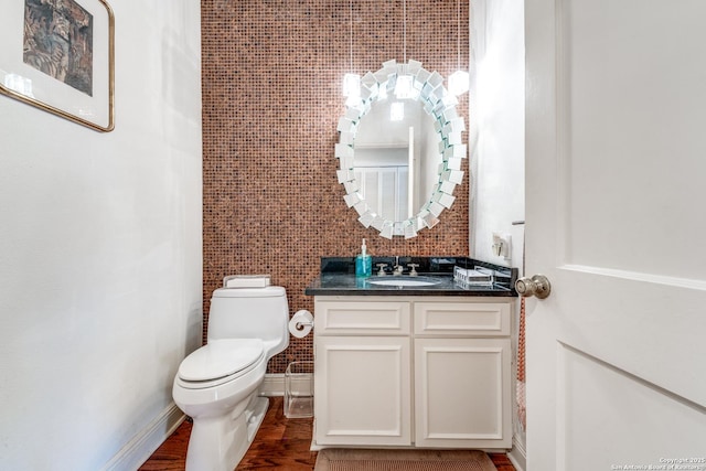 7731 Broadway Unit I-42, San Antonio, TX 78209 - bathroom with toilet, tile walls, wood finished floors, and vanity