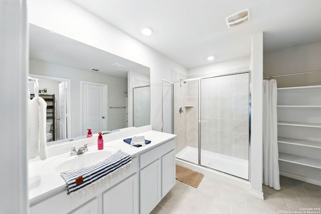 bathroom featuring visible vents, tile patterned flooring, a shower stall, vanity, and toilet