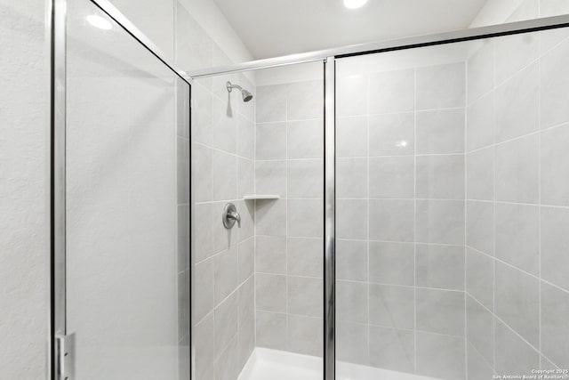 bathroom with recessed lighting and a shower stall