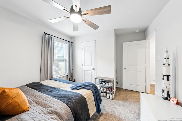 bedroom with a ceiling fan and light colored carpet