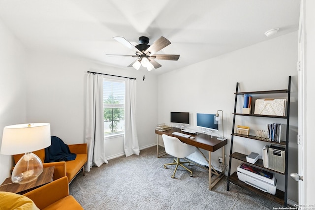 home office featuring carpet floors, ceiling fan, and baseboards